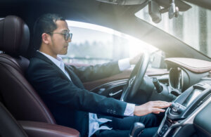 detail shot of young businessman driving his car.